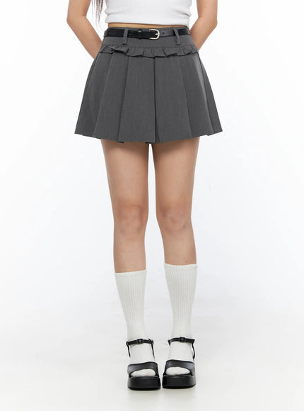 Pleated Mini Skirt CL517 Gray front shot on model showing full skirt length, black belt with silver buckle, ruffled waistband, white knee socks and black platform sandals