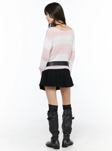 Pleated Mini Skirt CU530 Black back view on model styled with pink knit sweater and wide belt, full-length shot showing pleated hem