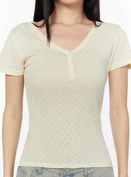 Pointelle Slim Henley V-Neck Tee IU524 Light beige close-up detail shot showing diamond pointelle knit texture V-neck and small button placket at chest