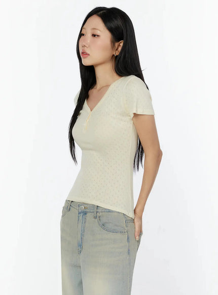 Pointelle Slim Henley V-Neck Tee IU524 Light beige side profile shot model standing facing left showing slim fit and short sleeve detail with straight-leg jeans