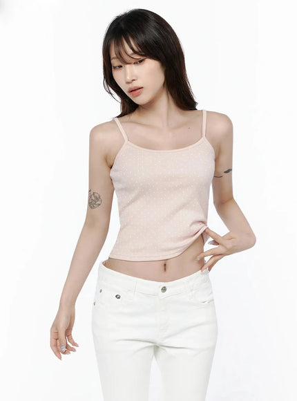 Polka Dot Cami Tank Top IL506 Pink upper-body front shot on model looking downward, hand on hip, cropped ribbed polka dot cami styled with white low-rise jeans