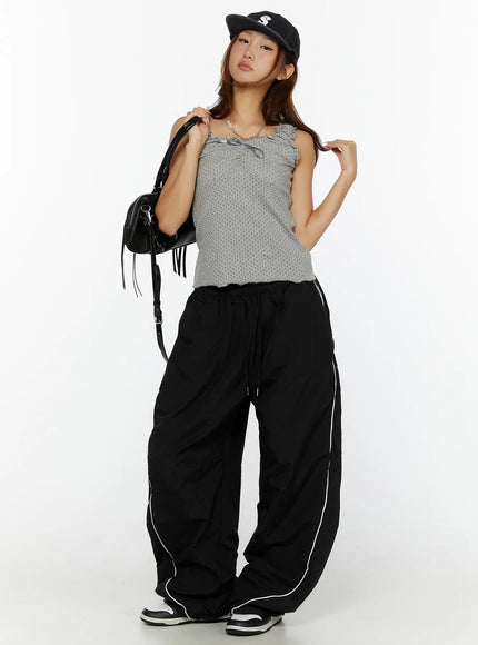 Polka Dot Frill Tank Top CL515 Gray full-body front model shot with black cap and bag, wide-leg track pants and sneakers, relaxed pose