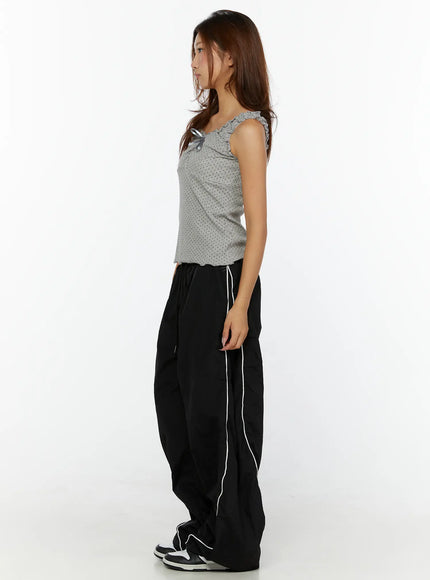 Polka Dot Frill Tank Top CL515 Gray side model shot showing ruffle strap and slim fit silhouette, styled with black track pants