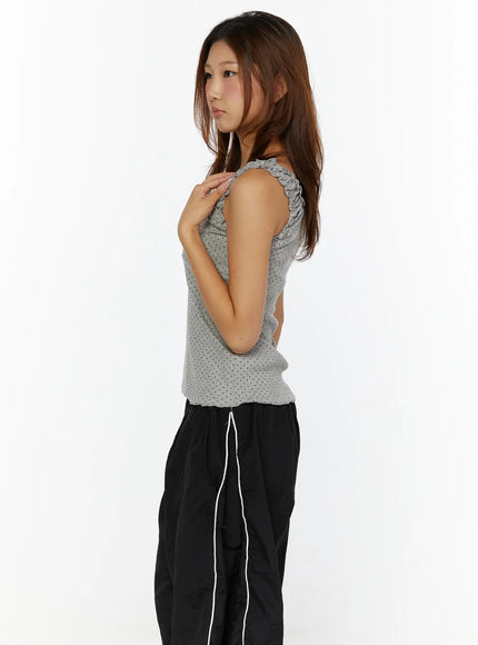 Polka Dot Frill Tank Top CL515 Gray close-up side model shot highlighting ruffle strap detail and polka dot knit texture, hand on shoulder