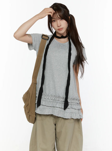 Polka Dot Frill Tee CL507 Gray front half-body shot model with canvas crossbody bag and black scarf choker hand raised to forehead casual street style