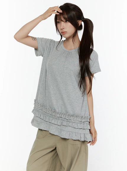 Polka Dot Frill Tee CL507 Gray front shot model hand raised to head showing three-tier ruffle hem with polka dot detail and relaxed oversized fit