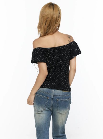 Polka Dot Frill Two-Way Tee CL528 Black back shot on model showing off-shoulder frill neckline, white dot print fabric, fitted silhouette, and bare upper back