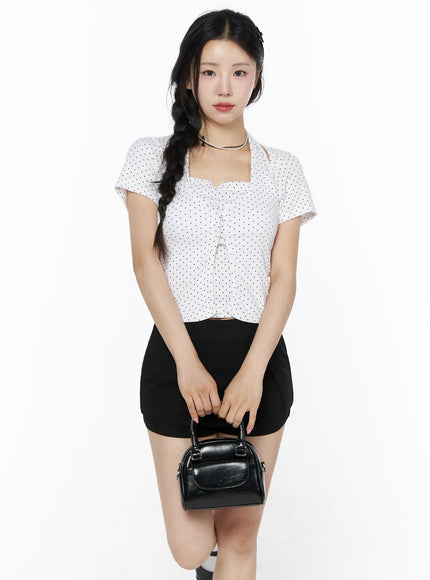 LEWKIN Polka Dot Halter Layered Tee IU525 White front shot on model S/M holding black mini bag, square neckline cut-out halter detail, polka dot crop top