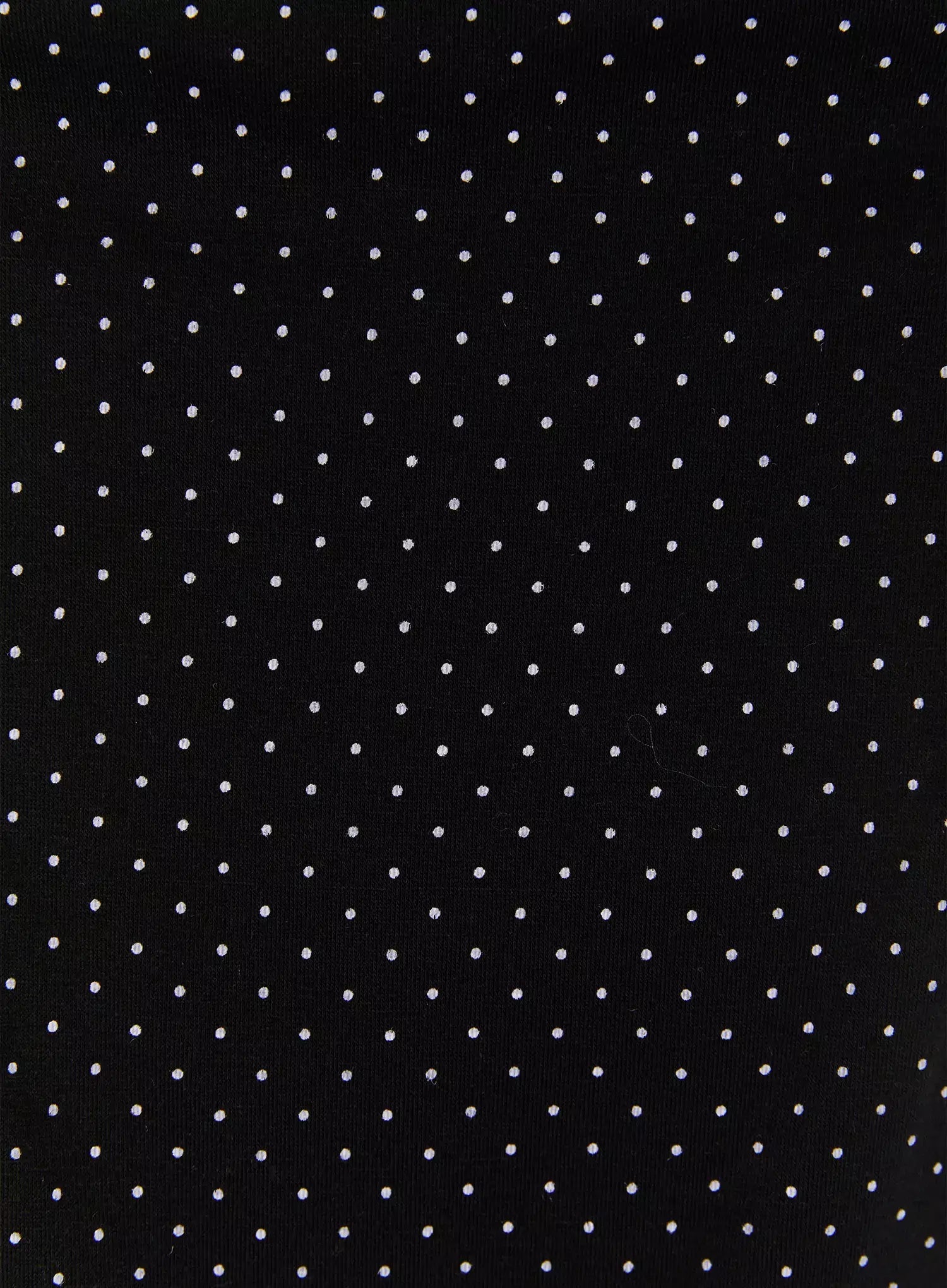 Polka Dot Halter Top IL502 Black fabric close-up showing black base with evenly scattered small white polka dot knit texture