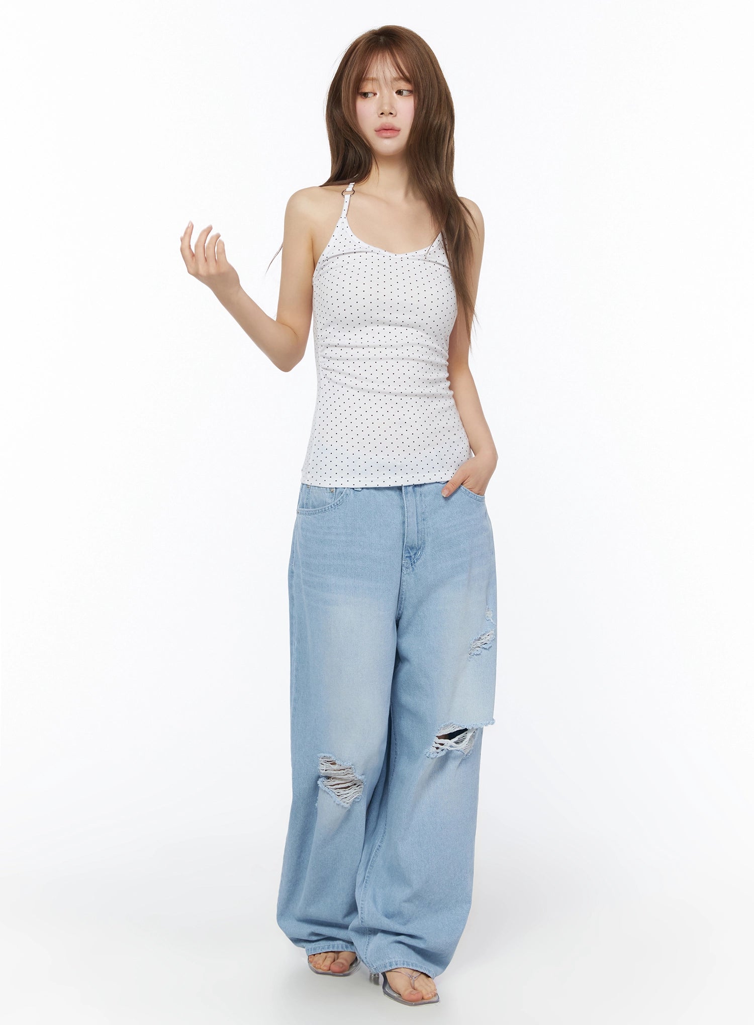 Polka Dot Halter Top IL502 White full-length front shot on model with one hand raised styled with ripped wide-leg denim