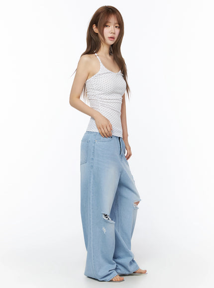 Polka Dot Halter Top IL502 White side shot on model with hand resting at hip showing fitted silhouette and halter strap detail