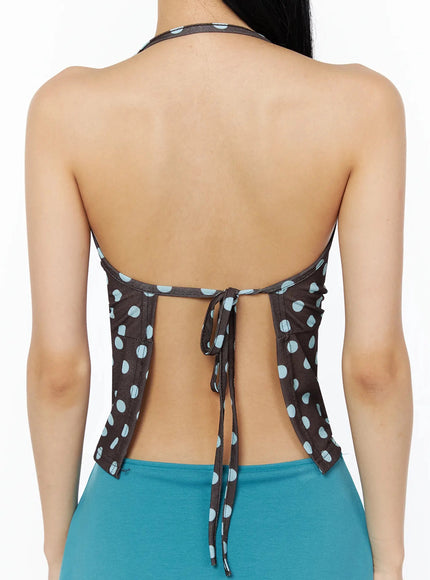 Polka Dot Halter Top IL509 Brown close-up back detail shot on model showing open back halter construction, center waist tie closure, blue polka dots on brown