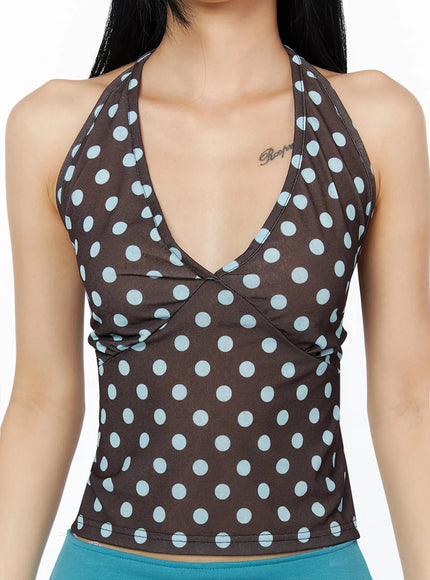 Polka Dot Halter Top IL509 Brown close-up front shot on model showing deep V-neck halter neckline and large light blue polka dot print on brown fabric