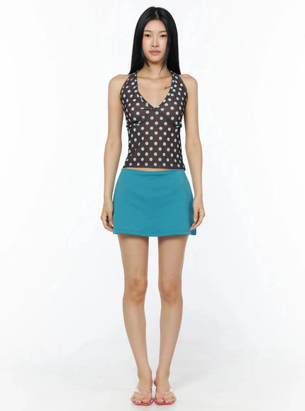 Polka Dot Halter Top IL509 Brown full-length front shot on model standing upright, brown halter with blue polka dots, teal mini skirt, pink flip-flops