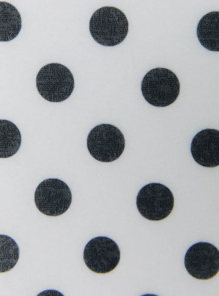 Polka Dot Halter Top IL509 White close-up fabric detail showing large dark navy polka dots on white smooth stretch fabric texture