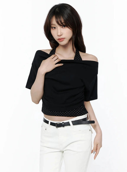 Polka Dot Layered Halter Neck T-Shirt IL506 Black front model shot with hand touching shoulder showcasing off-shoulder drape polka dot strap and ruched crop silhouette