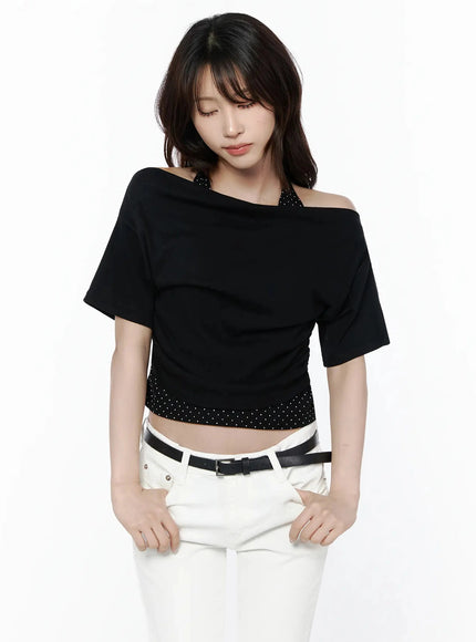 Polka Dot Layered Halter Neck T-Shirt IL506 Black front model shot looking downward hands at waist showing asymmetric off-shoulder and polka dot hem band with white jeans