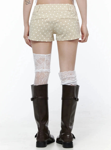 Polka Dot Mini Shorts IL506 Beige lower-body back shot on model showing rear pockets and white polka dot pattern, white lace socks above dark riding boots