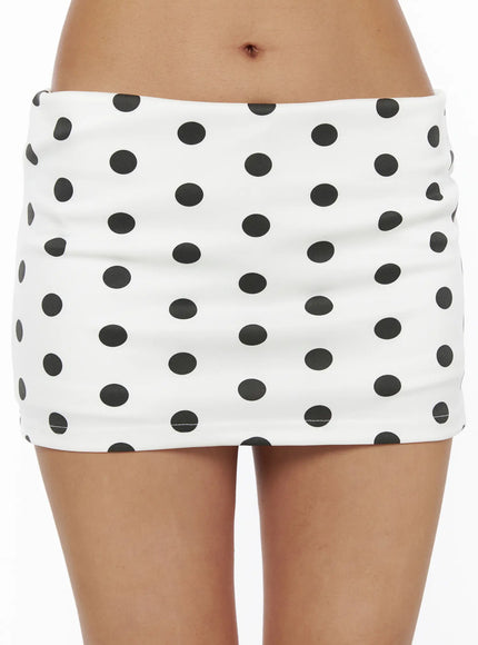 Polka Dot Mini Skirt CL503 Dot white close-up front detail shot on model showing large black polka dot print low-rise waistband and smooth fabric