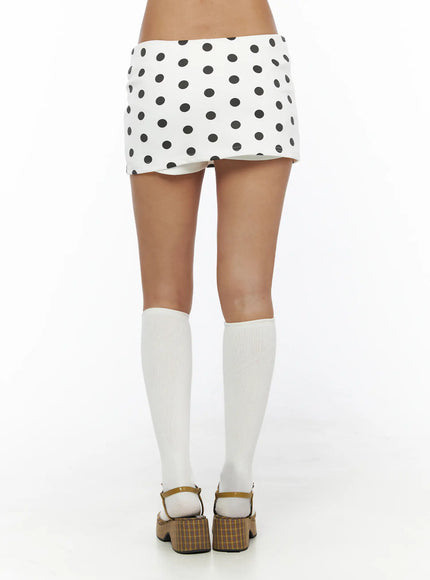 Polka Dot Mini Skirt CL503 Dot white back shot on model standing showing rear polka dot print low-rise waistband and hem detail