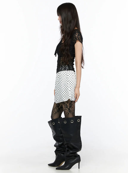 Polka Dot Ribbon Satin Mini Skirt CL522 White full-length side shot on model showing skirt silhouette and hem line paired with black lace top and slouchy knee boots