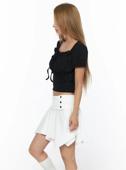 Polka Dot Shirred Puff Sleeve Top CU524 Black side view model standing showing front tie ribbon and shirred waist polka dot crop top with white socks
