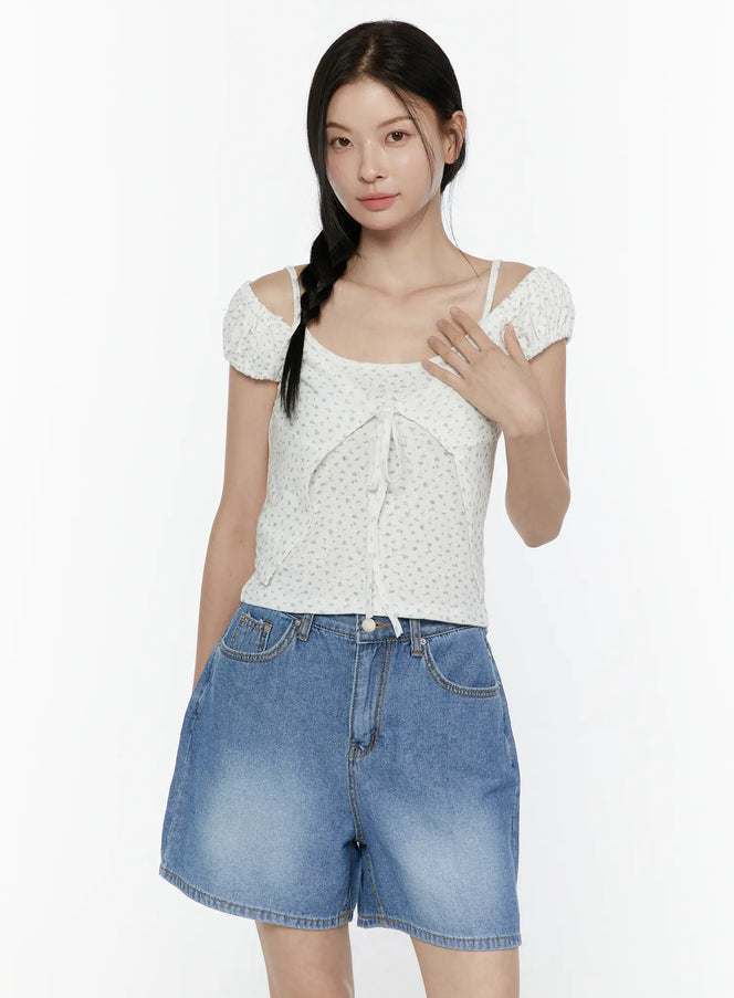 LEWKIN Puff Sleeve Floral Cami Top IL506 White front view on model wearing denim shorts, cold-shoulder puff sleeves with ribbon tie detail, S/M