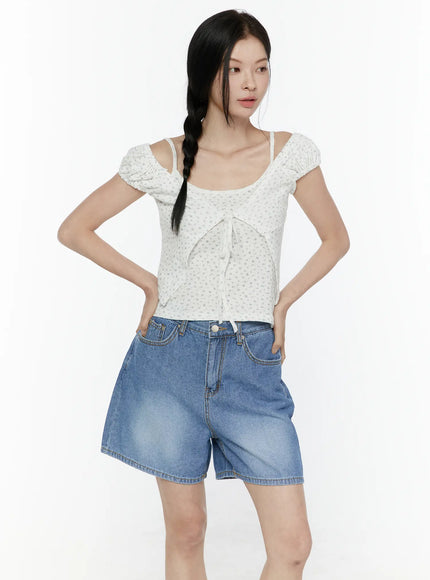 Puff Sleeve Floral Cami Top IL506 White front shot on model with hands on hips gazing away, floral texture and cold-shoulder strap design