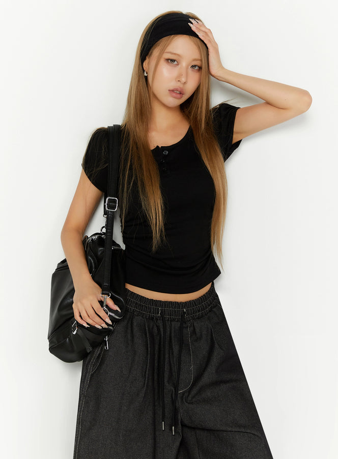 LEWKIN Puff Sleeve Henley Tee IL524 Black S/M front shot on model wearing headband and black bag styled with dark wide-leg denim pants