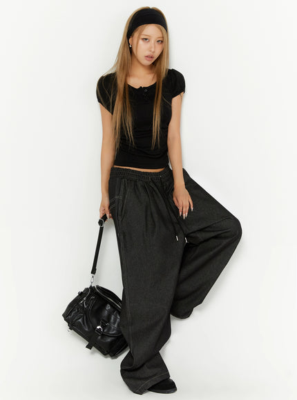 Puff Sleeve Henley Tee IL524 Black full-body front shot on model with headband holding black crossbody bag styled with dark wide-leg denim pants