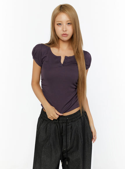 Puff Sleeve Henley Tee IL524 purple front shot on model standing straight showing scoop neck henley buttons and puff sleeves