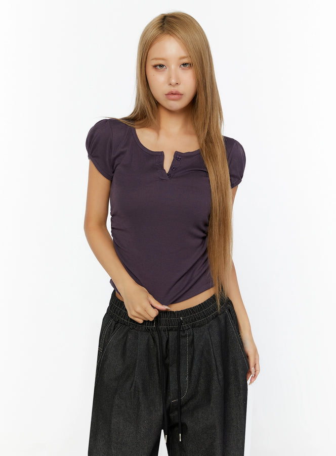 Puff Sleeve Henley Tee IL524 purple front shot on model standing straight showing scoop neck henley buttons and puff sleeves