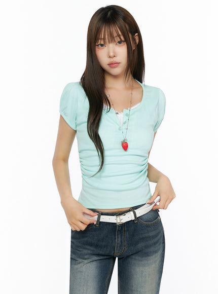 Puff Sleeve Tee IL523 Mint front shot on model half-body standing upright hands on belt puff sleeve henley neckline ruched body ribbed knit