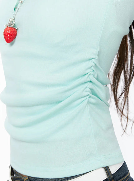 Puff Sleeve Tee IL523 Mint detail close-up showing side ruched waist gathering ribbed mint fabric texture with strawberry charm necklace accent