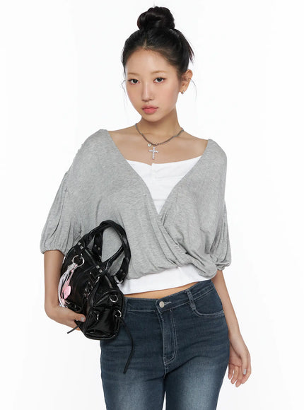 LEWKIN Puff Wrap V-Neck Tee CL510 Gray S/M front close-up on model with bun updo, crossover V-neckline, puff sleeves, layered over white cami, styled with dark jeans and black bag