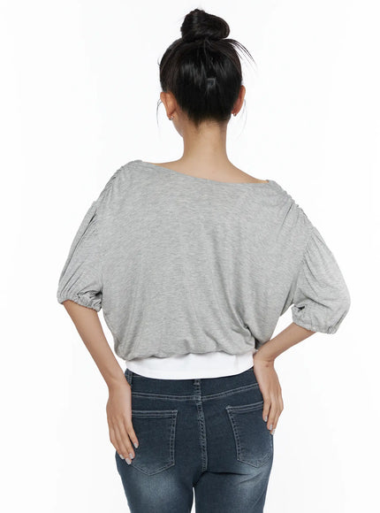 Puff Wrap V-Neck Tee CL510 Gray back shot on model with bun updo, wide boat neckline, oversized draped back, elasticated puff sleeves, white cami hem peeking below, paired with dark jeans