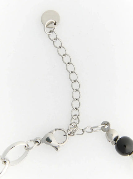 Raven Halloween Bracelet IL522 black close-up detail of silver lobster clasp and adjustable extender chain with round end disc on white background