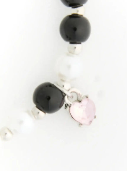 Raven Halloween Bracelet IL522 black close-up detail of alternating black onyx and white pearl beads with silver spacer accents and dangling pink heart crystal charm
