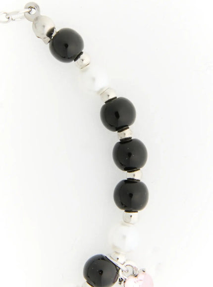 Raven Halloween Bracelet IL522 black close-up detail of glossy black onyx beads and white pearl beads strung with silver rondelle spacers on bead strand