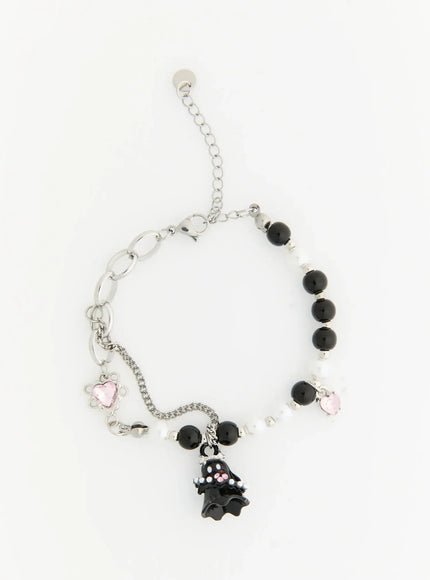 Raven Halloween Bracelet IL522 black flat-lay full view showing ghost charm, alternating black onyx and white pearl beads, pink heart crystal charms, silver lobster clasp extender
