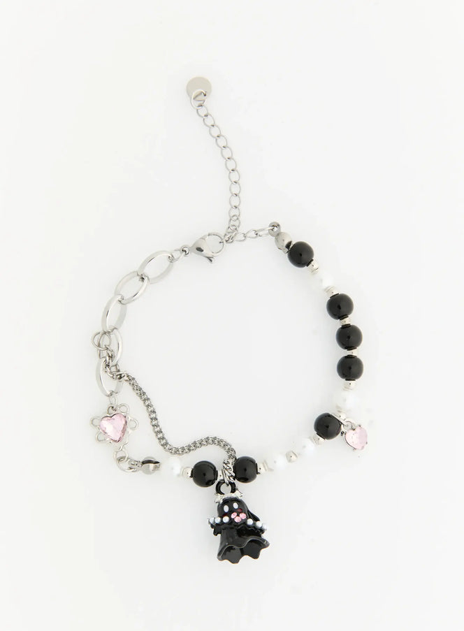 Raven Halloween Bracelet IL522 black flat-lay full view showing ghost charm, alternating black onyx and white pearl beads, pink heart crystal charms, silver lobster clasp extender