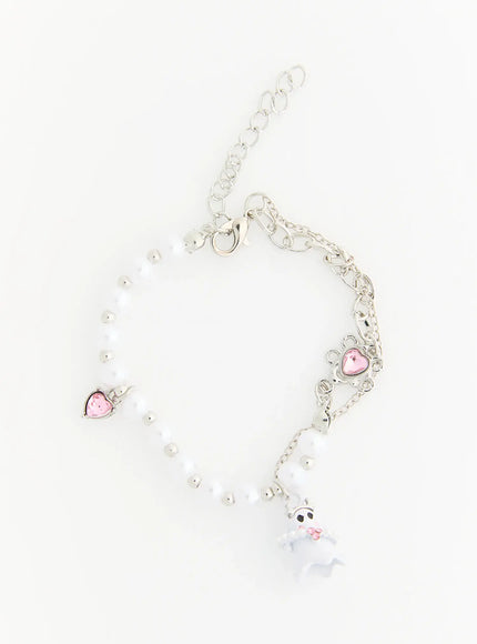 Raven Halloween Bracelet IL522 white flat-lay full view showing white ghost charm, white pearl beads, silver chain, pink heart crystal charms and lobster clasp extender