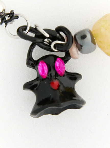 Raven Halloween Necklace IL517 Black close-up detail of black enamel ghost pendant with pink crystal eyes and red heart accent