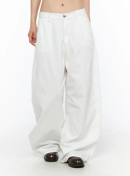 Relaxed Fit Baggy Pants CL502 White front angled view on model showing low-rise wide-leg silhouette contrast stitching and voluminous drape with dark loafers