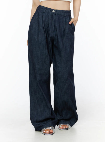 Relaxed-Fit Wide-Leg Pants IU525 Dark blue front mid-shot on model with hand in pocket showing pleated high-rise waistband and voluminous wide-leg denim