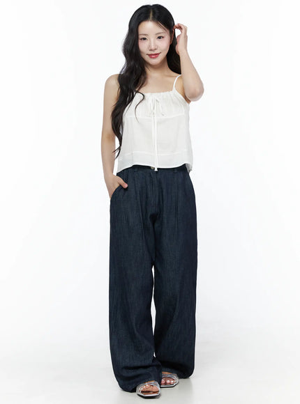 Relaxed-Fit Wide-Leg Pants IU525 Dark blue full-body front shot on model smiling hand raised to hair styled with white cami top and silver flat sandals