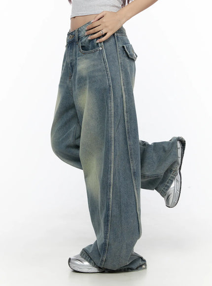 Rey Vintage Washed Wide Leg Jeans CL524 Blue side shot on model with one leg raised, visible side seam and vintage faded denim texture