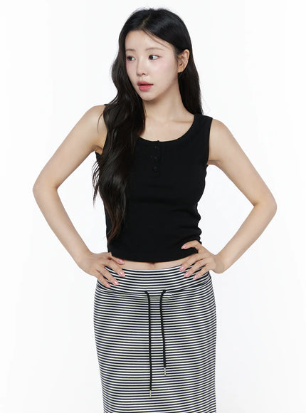 Ribbed Button Tank Top IU525 Black front model shot hands on hips gazing sideways showing three-button henley placket and cropped ribbed silhouette