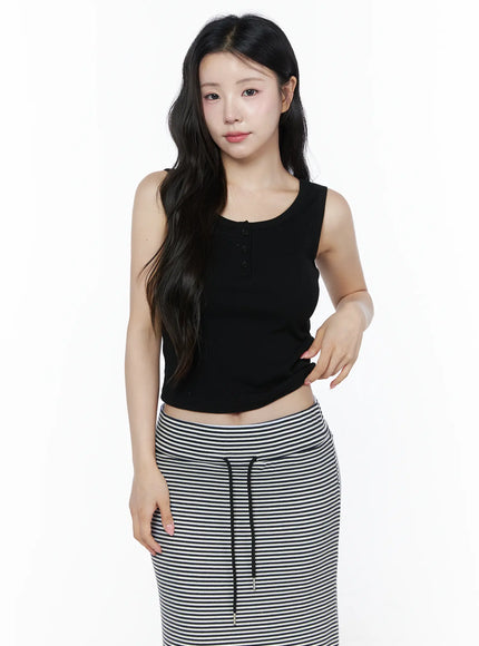 Ribbed Button Tank Top IU525 Black front model half-body shot hands on hips button detail visible ribbed crop tank styled with stripe drawstring skirt