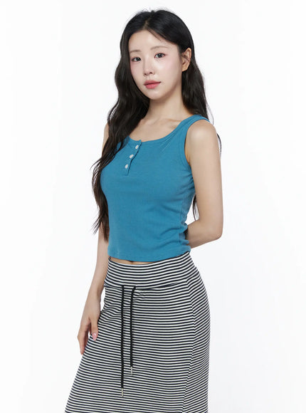 Ribbed Button Tank Top IU525 Blue three-quarter side model shot showing ribbed henley crop tank with white buttons styled with black and white striped skirt